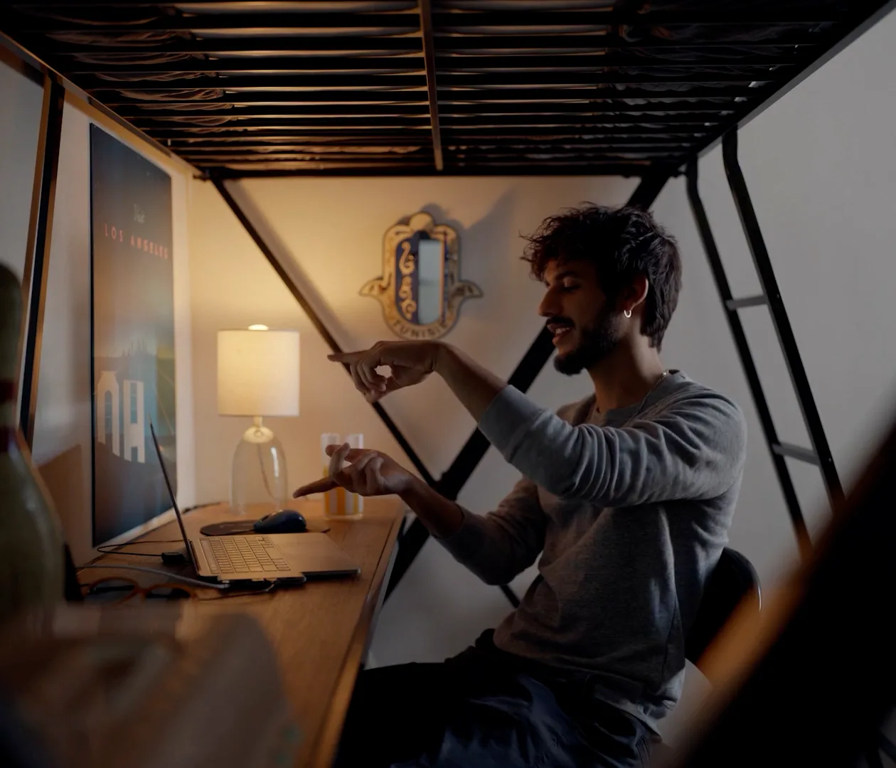 A documentary shoot in progress — the subject at his desk framed through the camera rig.